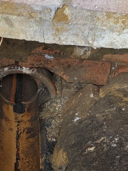 holes in a drain allowing for rodents to gain entry