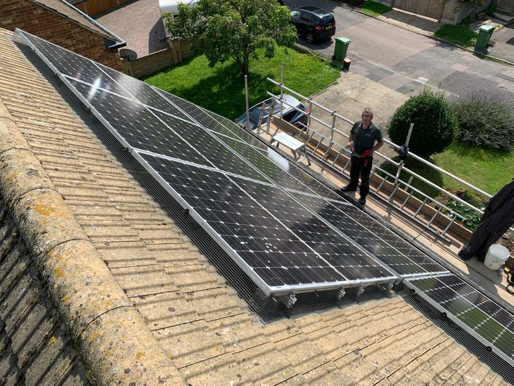 pest-tech technicians using scaffolding to bird proof solar panels on a roof in sittingbourne