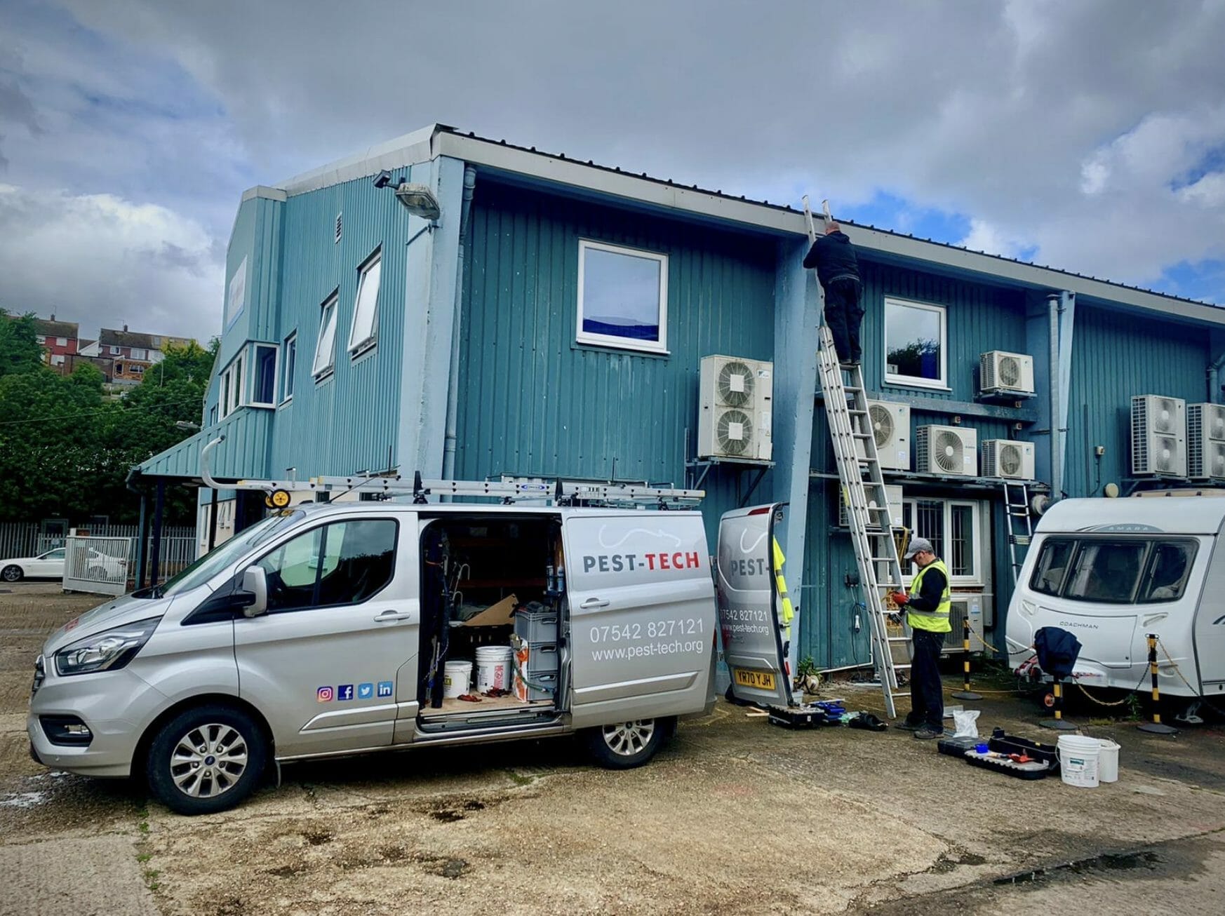 pest tech technicians and branded vans during a commercial pest control service performed at a medway business