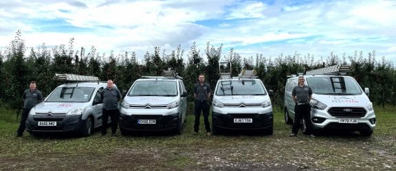 pest tech technicians next to branded vans in medway