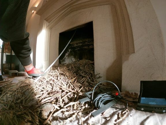 Birds nesting in the chimney and their nesting material